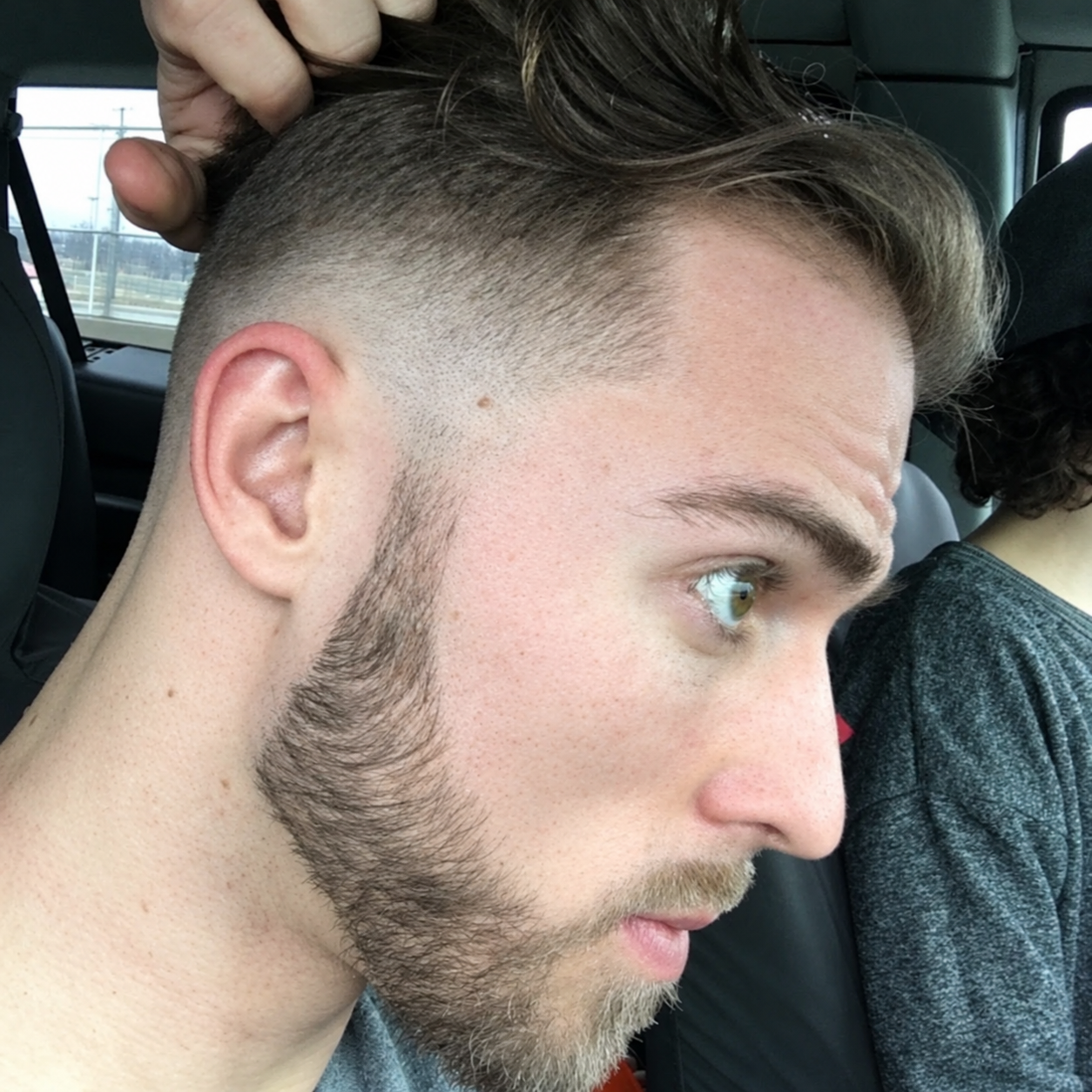 Skin fade haircut with textured hair on top